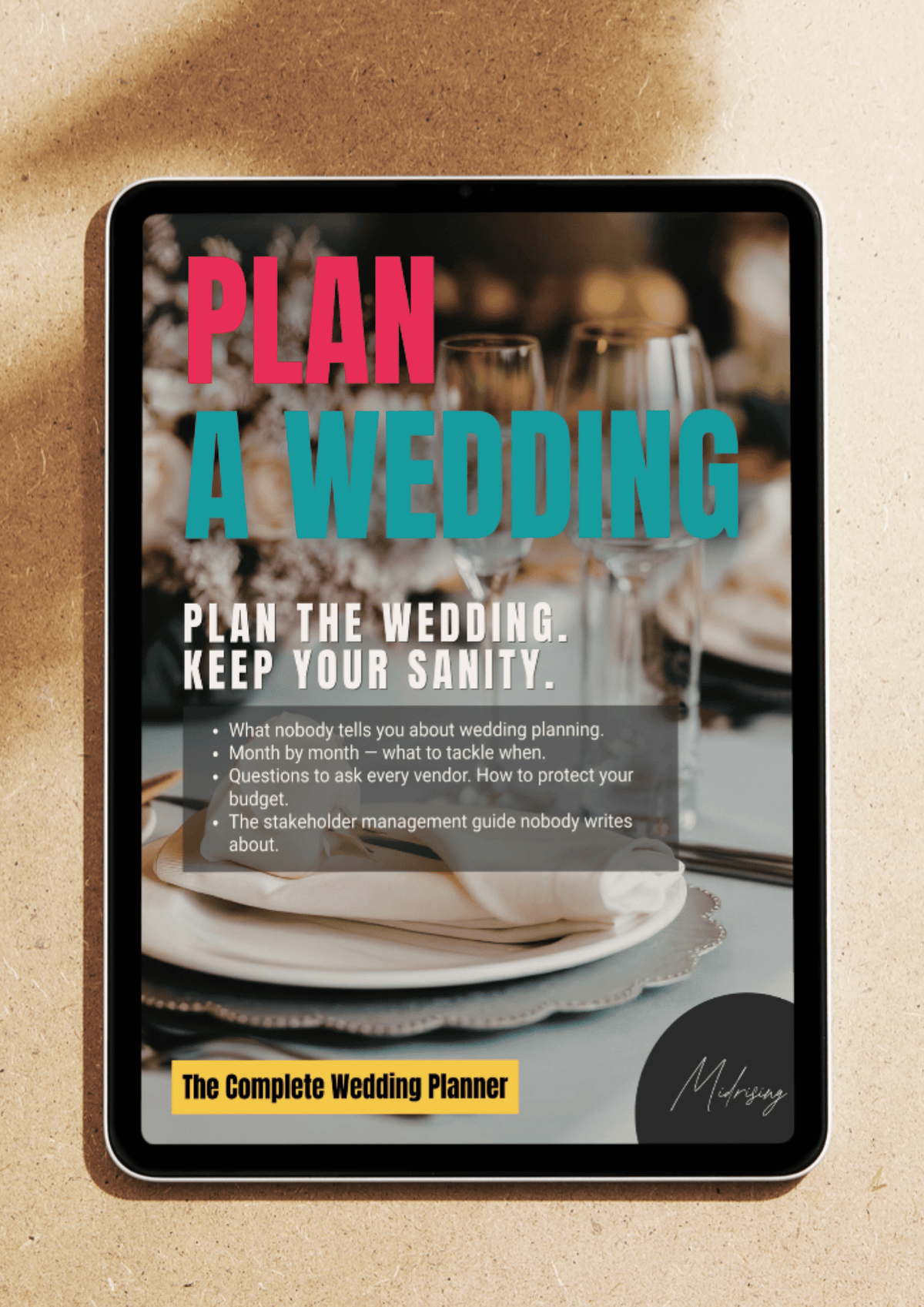 A tablet device displaying a wedding planner cover with large pink and teal text reading 'PLAN A WEDDING' over a blurred dinner table scene. The tablet is photographed on a warm beige textured surface with soft shadows.