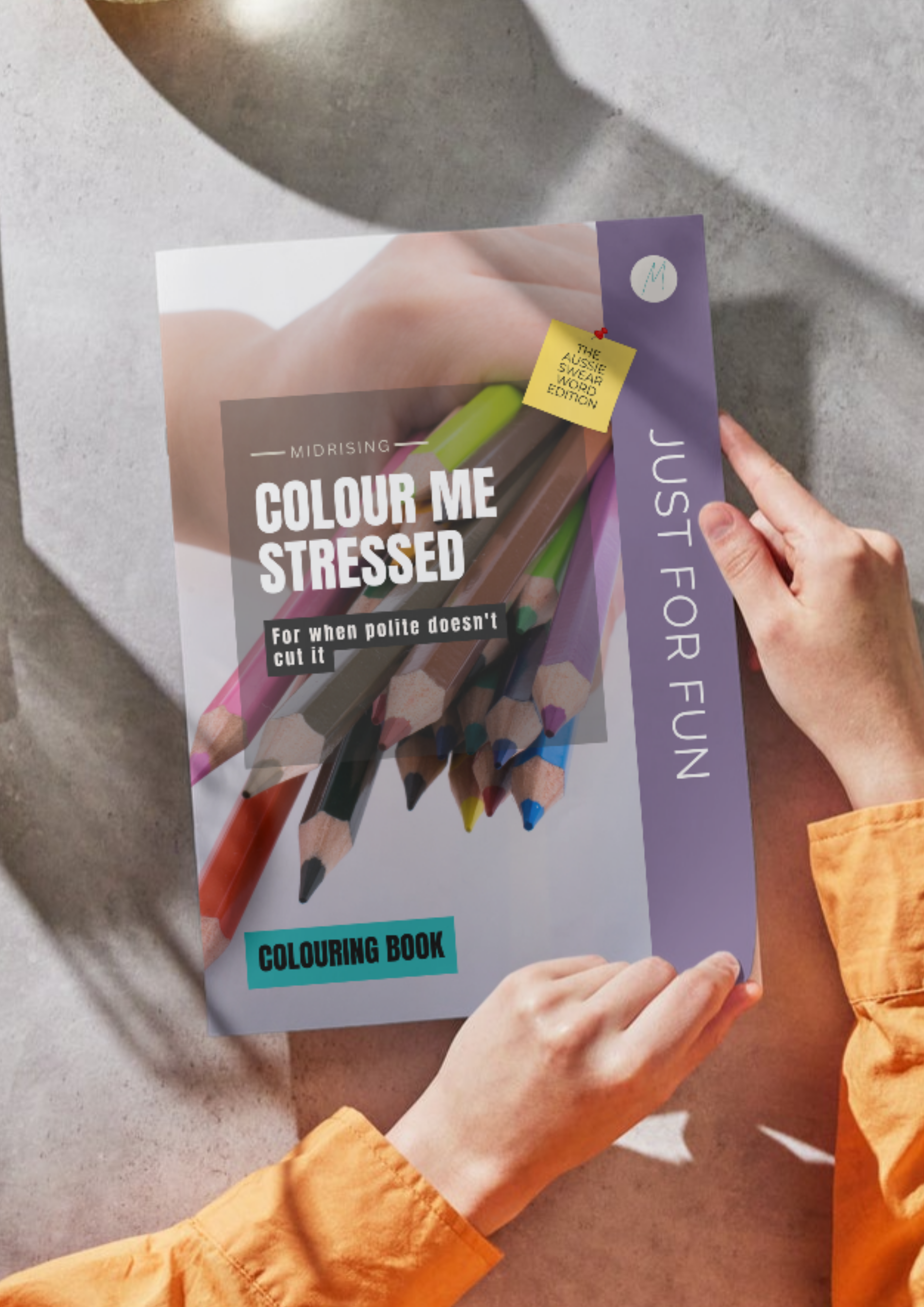 Woman holding the Colour Me Stressed Aussie swear word colouring book by Midrising