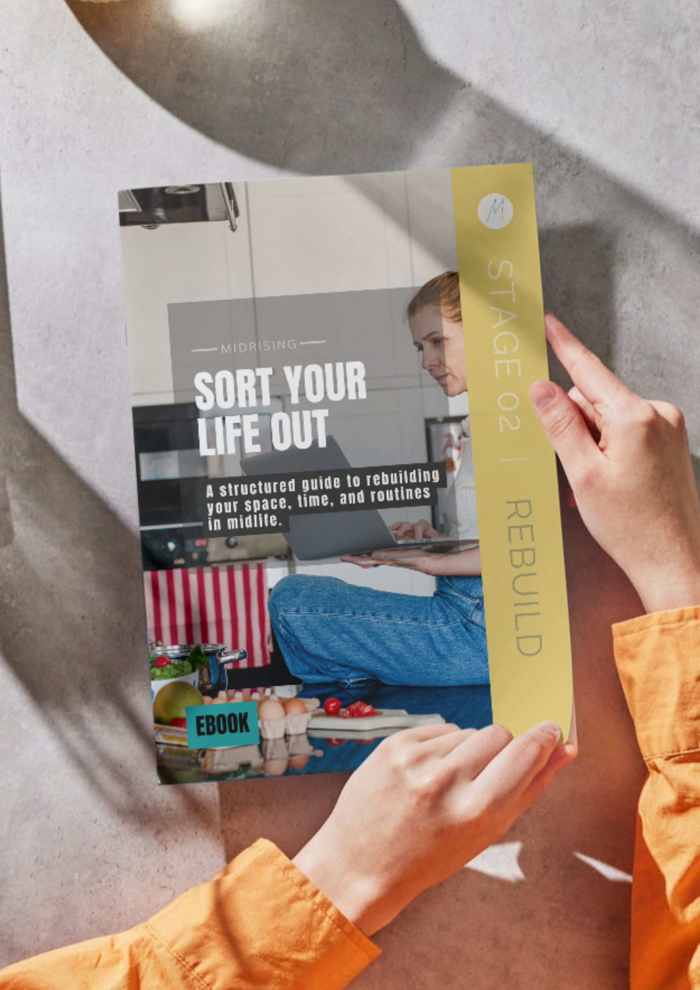 Sort Your Life Out Midrising ebook shown as a booklet in hand — a guide for Gen X women rebuilding their routines in midlife. Stage 02 Rebuild.